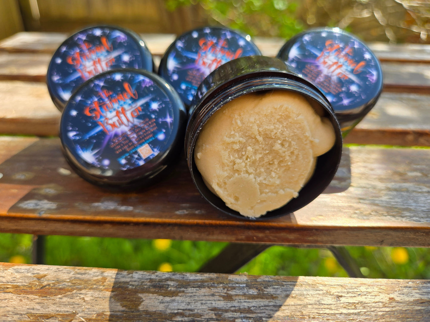 Starriel Beard Butter containers on a wooden table, showcasing organic beard conditioning cream.