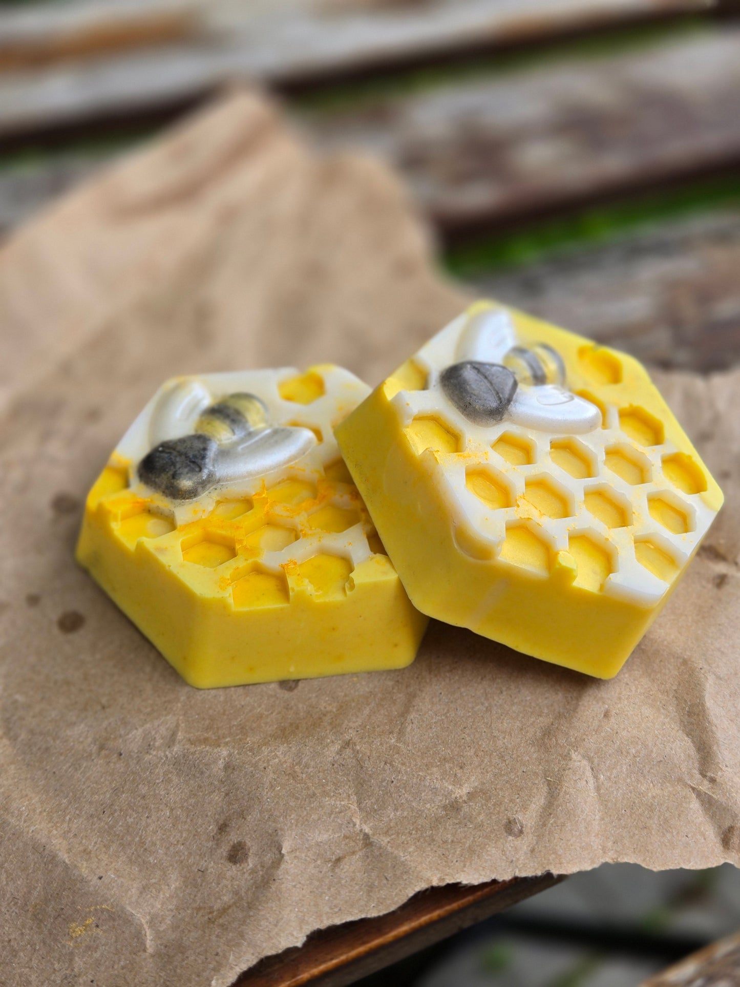 Hexagonal honey bar soap with honeycomb design, infused with turmeric and nourishing ingredients.
