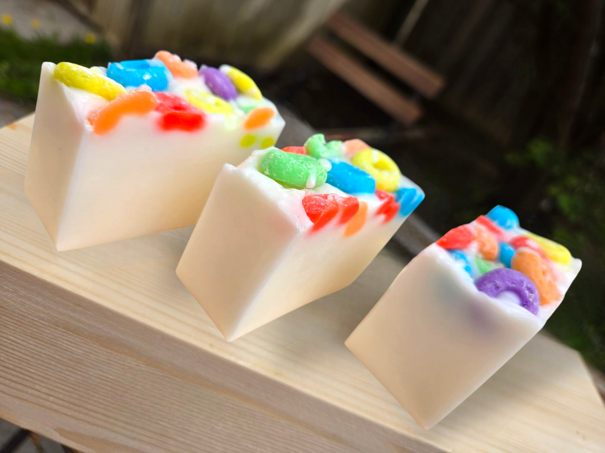 Frooty Loops Bar Soap with colorful cereal-like topping on wooden surface.