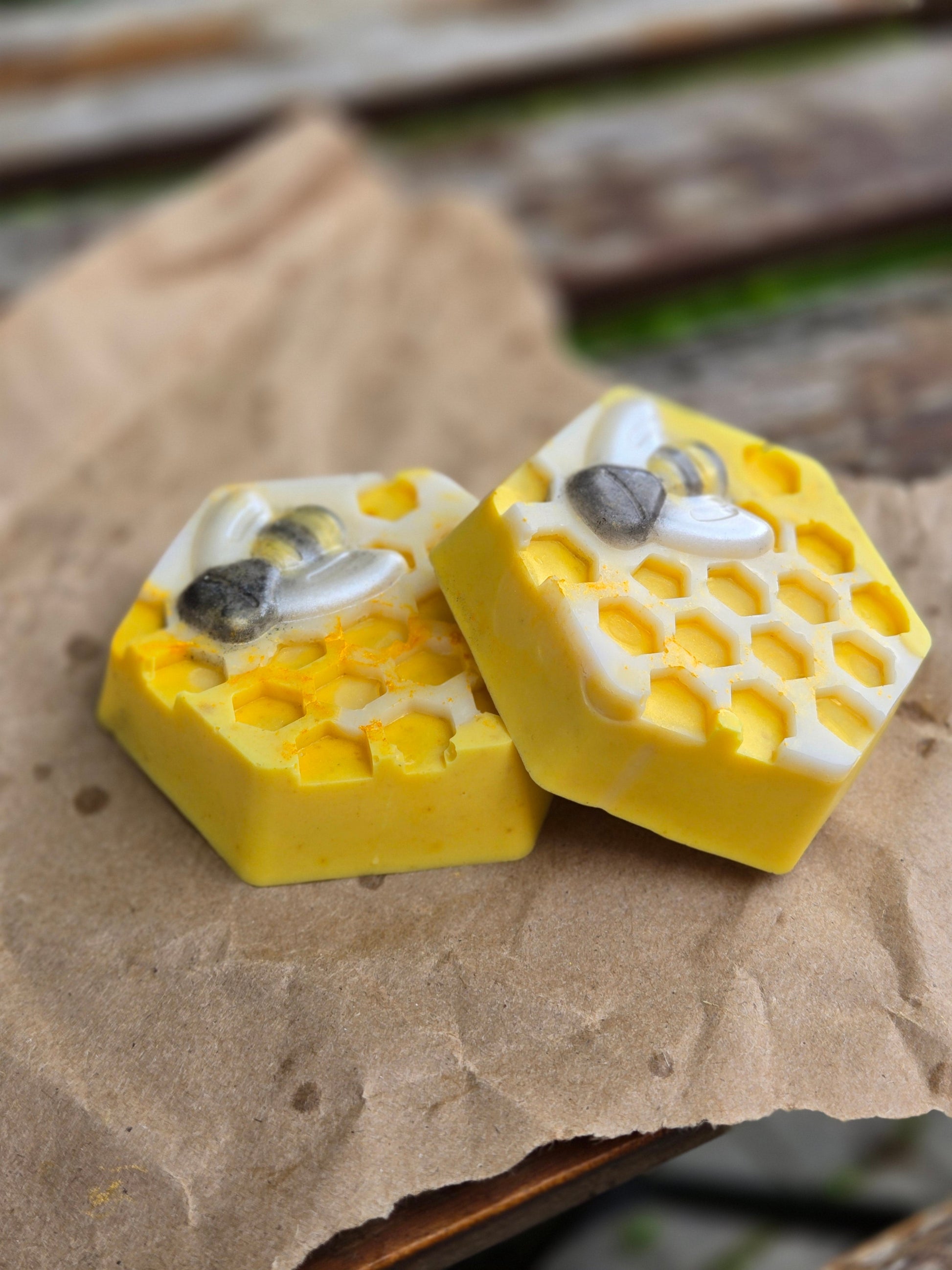 Hexagonal honey bar soap with honeycomb design, infused with turmeric and nourishing ingredients.