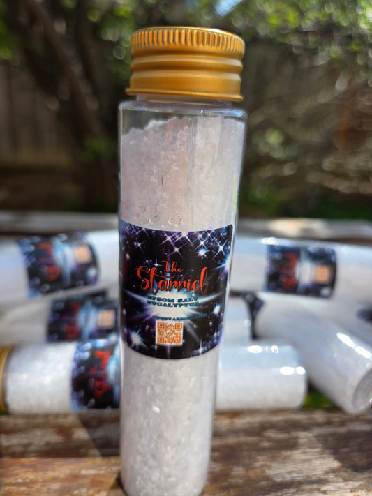 Epsom Salts in clear bottle with gold cap, labeled 'The Starry' against a wooden background.